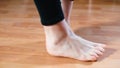 Closeup of legs of a woman doing a dance move moonwalk.