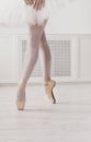 Closeup legs of young ballerina in pointe shoes, ballet practice