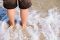 Girl stand on the beach with sea foam Royalty Free Stock Photo
