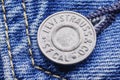 Closeup of Levi Strauss button on blue jeans.