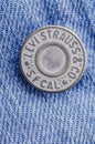 Closeup of Levi Strauss button on blue jeans. Royalty Free Stock Photo