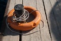 Close up of lifebuoy. Rescue equipment for emergency on water. Lifebuoy and mooring cannon on dock Royalty Free Stock Photo