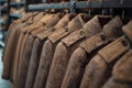 Closeup of light brown coats on hangers in store showcasing classic womenswear. Concept Fashion