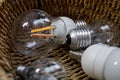 Closeup of lightbulbs in a wicker basket - recycling, energy crisis and lack of inspiration concept Royalty Free Stock Photo