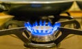 Closeup of a lighted gas cooker, burning blue flames, vintage kitchen equipment Royalty Free Stock Photo