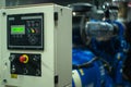 Closeup lighting indicator on the control cabinet in the electrical room with blurred electrical generator in background