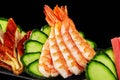 Closeup of lightly poached shrimps on platter with grilled unagi eel, tuna sashimi and cucumber Royalty Free Stock Photo
