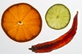 Closeup of lime and orange slices with a dried red pepper isolated on a white background Royalty Free Stock Photo