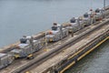 Closeup, line of ship building tractors at Gatun locks quay, Panama Canal