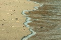 Closeup line water foam over clean sand on beach