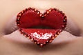 Closeup lips with red heart make-up & rhinestones. Valentines Day style