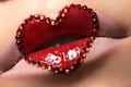 Closeup lips with red heart make-up & rhinestones. Valentines Day style