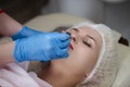 Closeup of Lips of Woman Having Permanent Lips Makeup at Beauty Salon During Permanent Makeup Tattoo While Drawing Contour with Royalty Free Stock Photo