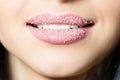 Closeup on lips of young woman in sugar pleasantly softly smiling white teeth