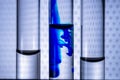 Closeup liquid of blue color ink in water in a test tube of vitro. Concept idea on a medical theme.