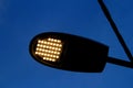 Closeup of the lit ledd lights of a street lamp on the street at dusk Royalty Free Stock Photo