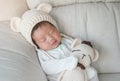 Closeup a baby sleeping comfortably on sofa with bear doll Royalty Free Stock Photo