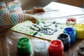 Closeup of little creative toddler girl painting with finger colors an owl bird. Child having fun with drawing at home Royalty Free Stock Photo