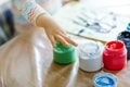 Closeup of little creative toddler girl painting with finger colors an owl bird. Child having fun with drawing at home Royalty Free Stock Photo