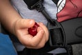 Closeup of a little cute baby hand holding a red cherry - childhood Royalty Free Stock Photo
