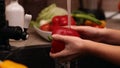 Closeup of little girl hands washing a red bellpepper