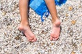 Closeup of little girl legs on tropical beach with Royalty Free Stock Photo
