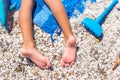 Closeup of little girl legs on tropical beach with Royalty Free Stock Photo