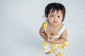 Closeup little girl with swollen eye from insect bite with red bruise on white tiled floor background Royalty Free Stock Photo