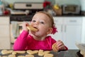 Closeup of little girl taking a bite out of a heart shaped sugar cookie Royalty Free Stock Photo