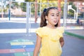 Closeup of a  little pretty girl sticking tongue out with hopscotch in the background Royalty Free Stock Photo