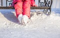 Closeup of little skater's legs standing on winter