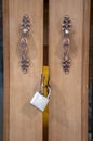 Closeup on locked padlock on wooden door