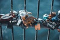 Closeup of locks of love put on a bridge over flowing water in Evans, Georgia