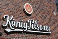 Closeup of logo lettering of german kÃÂ¶nig pilsener beer brewery at brick wall