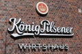 Closeup of logo lettering of german kÃÂ¶nig pilsener beer brewery at brick wall