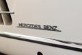 Closeup of the logo of Mercedes Benz on a vintage model car