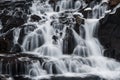 Closeup long exposure of turquoise deep blue Hraunfossar waterfall cascade Hvita River in Husafell Reykholt Iceland Royalty Free Stock Photo