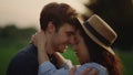 Romantic man and woman spending date on meadow. Couple dancing on field