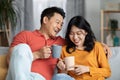 Closeup of loving asian spouses drinking tea together Royalty Free Stock Photo