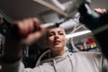 Closeup low-angle view of pretty blonde cycling mechanic female repairing and fixing mountain bicycle working in bike Royalty Free Stock Photo