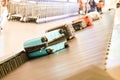 Closeup of luggage bag on airport conveyor belt for pickup Royalty Free Stock Photo