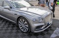 Closeup of a luxurious silver hybrid car Bentley Bentayga