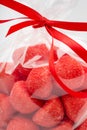 Closeup on luxury bag of candy strawberries with red ribbon Royalty Free Stock Photo