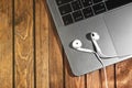 Macbook and Earpods on the wooden table