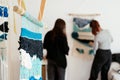 Closeup of macrame wall-hanging decorations weaved by two females