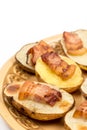 Closeup macro baked potatoes with fried bacon