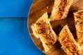 Closeup macro flat lay domestic cheese pie slices served on the round board