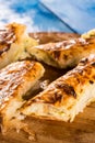 Closeup macro flat lay domestic cheese pie slices served on the round board