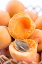 Closeup macro opened fresh apricots in the bowl.