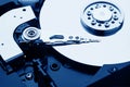 Closeup macro photo of head in opened hard disk drive. Concept of repair or recovery information from broken HDD. Royalty Free Stock Photo